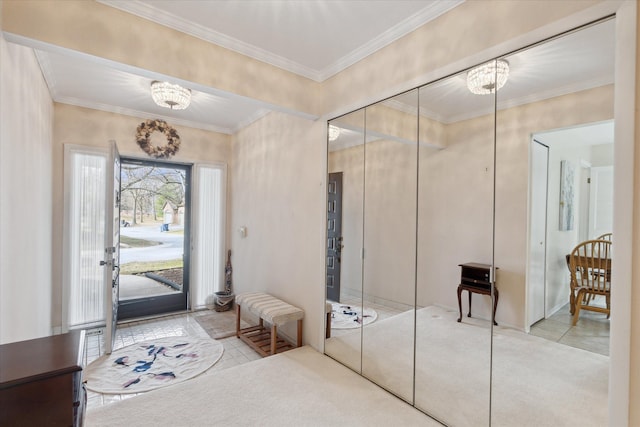 entryway with a notable chandelier and ornamental molding