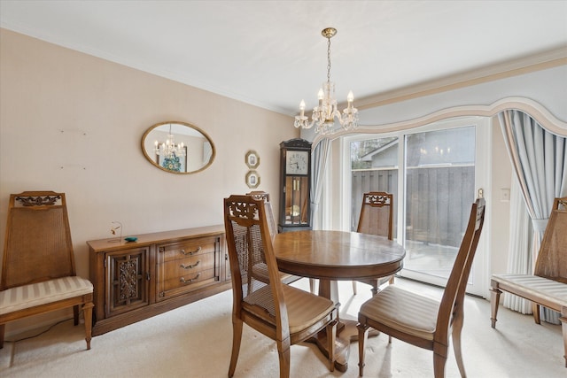 dining space with light carpet, a notable chandelier, and ornamental molding