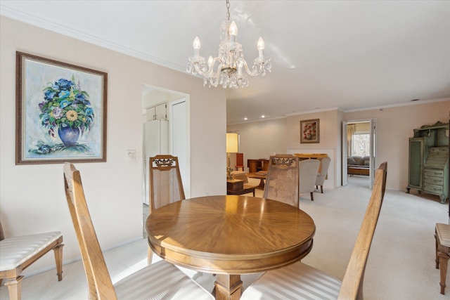 dining area featuring a notable chandelier, light colored carpet, and crown molding