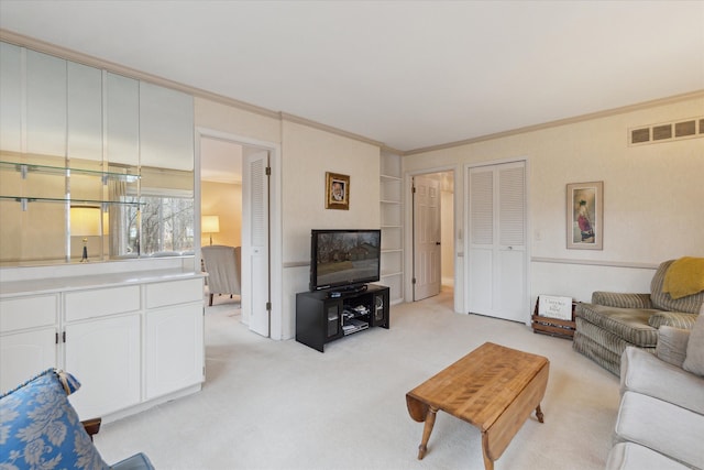 living room with light colored carpet, visible vents, and ornamental molding