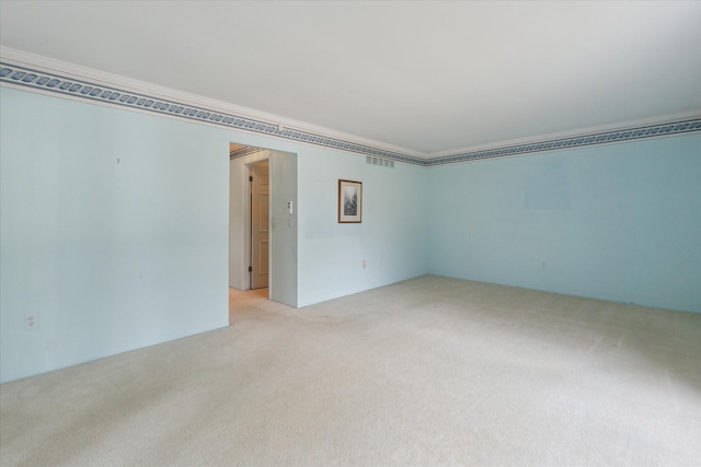 spare room with visible vents and light carpet