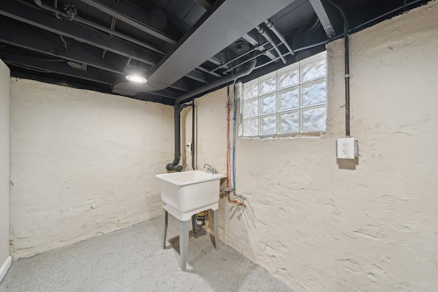 basement with a sink and a textured wall