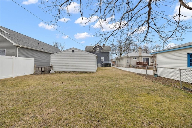 view of yard featuring an outdoor structure and a fenced backyard