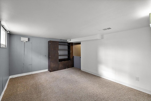 carpeted empty room with visible vents and baseboards