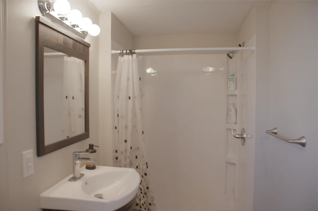 full bath with a shower with curtain and a sink