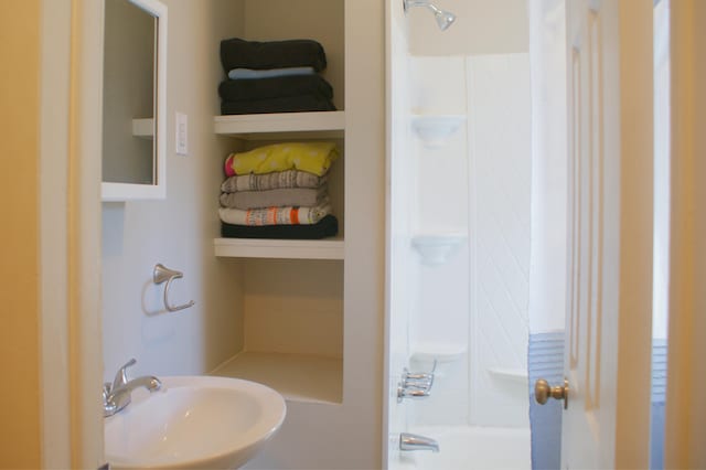 full bath with a sink and washtub / shower combination