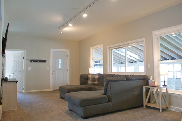 carpeted living area with visible vents and baseboards