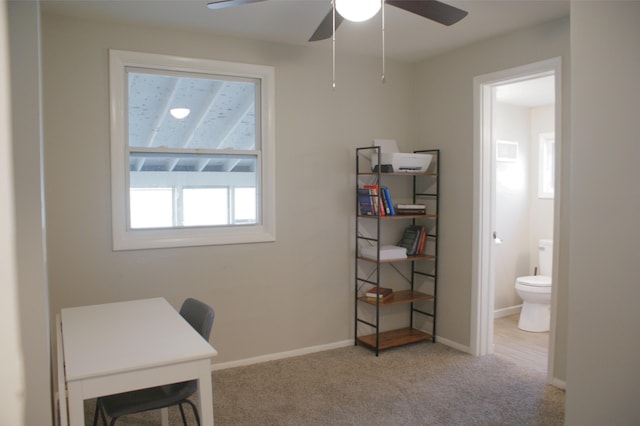 carpeted office with baseboards and ceiling fan