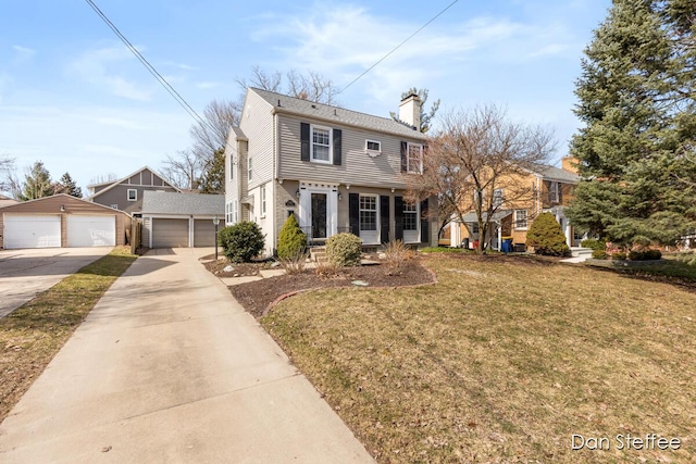 colonial inspired home featuring a front yard, a garage, an outdoor structure, and a chimney