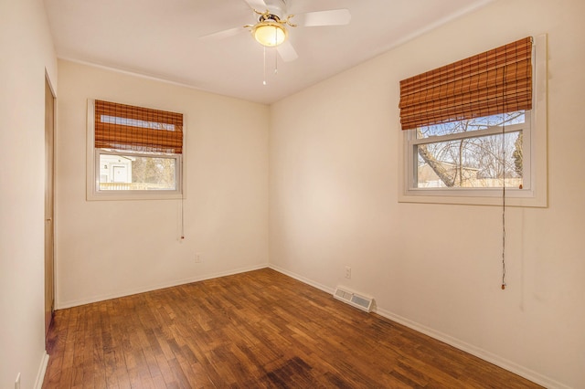 empty room with visible vents, baseboards, a ceiling fan, and wood-type flooring