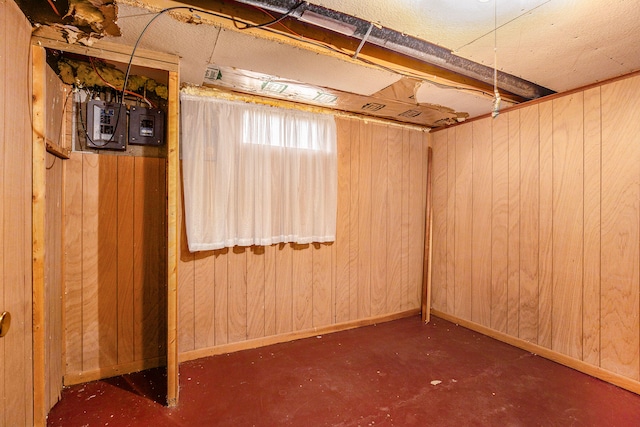 basement featuring wooden walls and baseboards