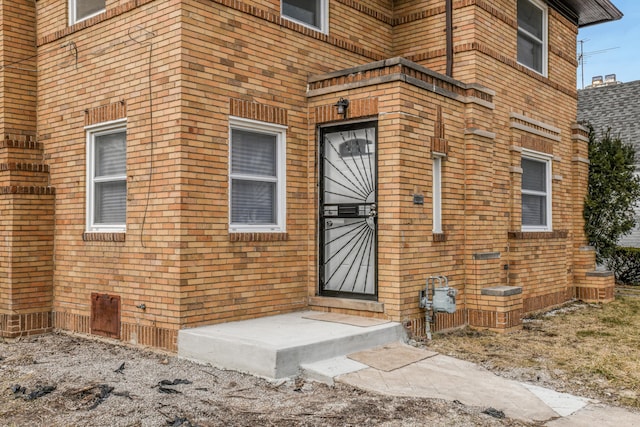 property entrance with brick siding