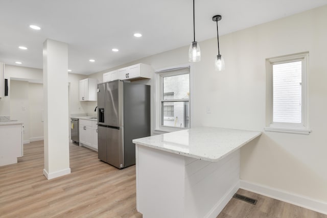 kitchen featuring visible vents, appliances with stainless steel finishes, a peninsula, and white cabinetry