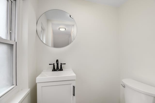 half bathroom featuring toilet and vanity