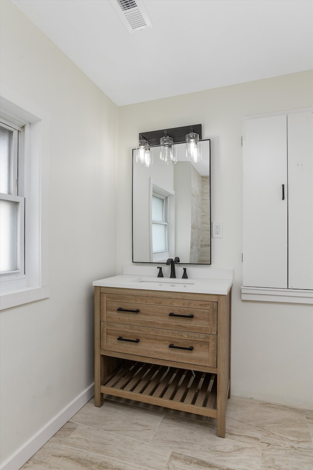 bathroom featuring vanity, wood finished floors, baseboards, and visible vents