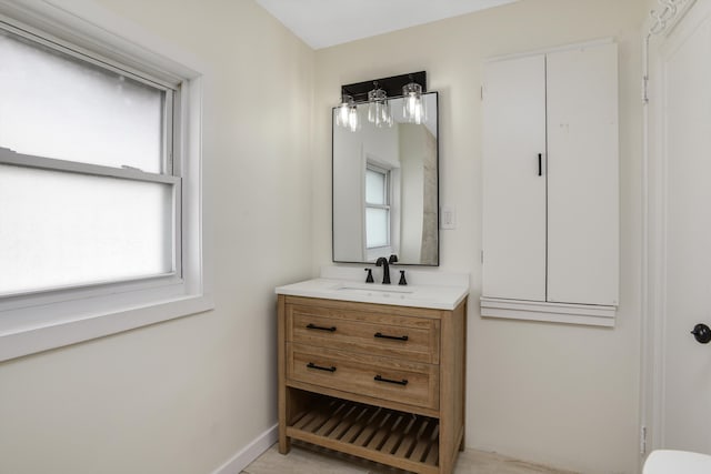 bathroom featuring vanity and baseboards