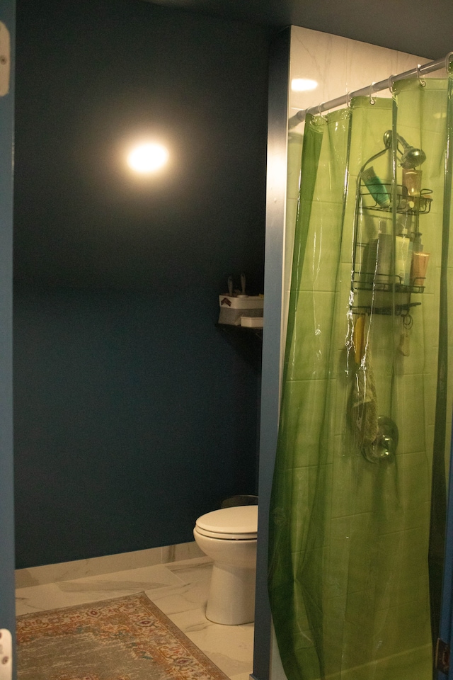 bathroom featuring toilet and a shower with curtain