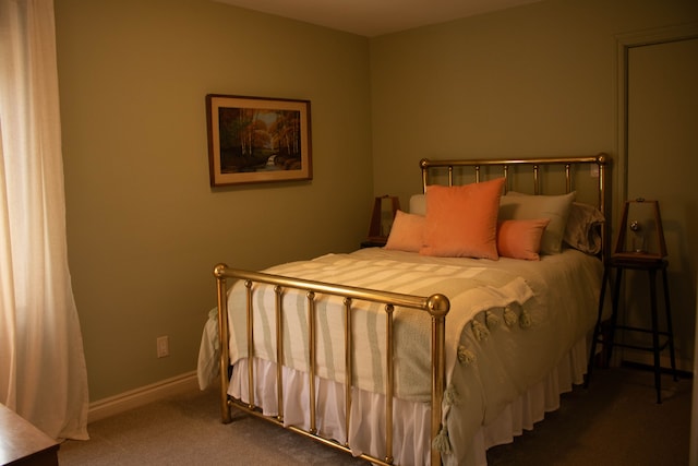 bedroom featuring baseboards and carpet