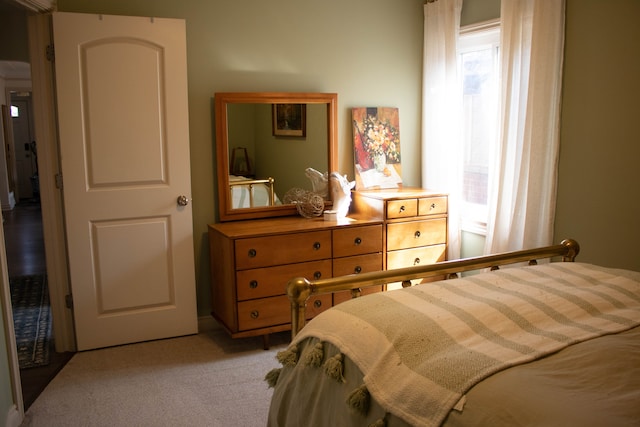 bedroom featuring light carpet