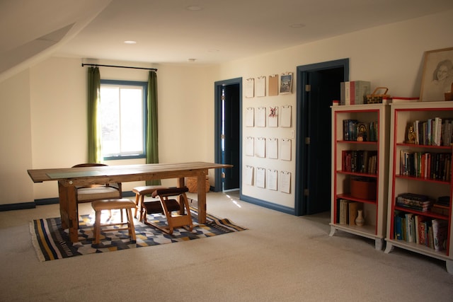 dining area with lofted ceiling, baseboards, and carpet floors