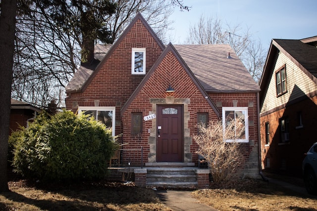 tudor-style house with brick siding and roof with shingles