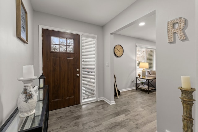 entryway with recessed lighting, baseboards, and wood finished floors