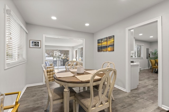 dining space with a wealth of natural light, recessed lighting, and wood finished floors