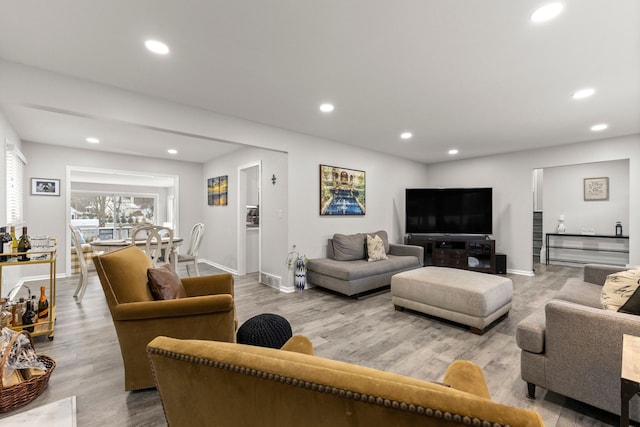 living area featuring wood finished floors, recessed lighting, and baseboards