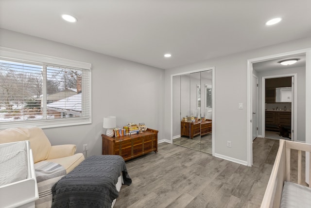 sitting room featuring recessed lighting, baseboards, and light wood finished floors