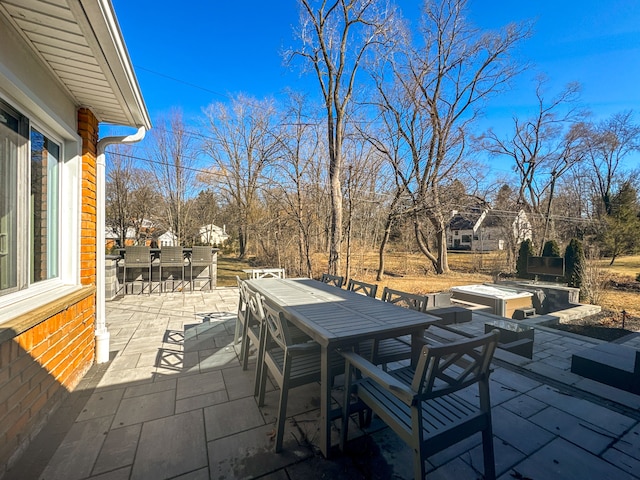 view of patio / terrace with outdoor dining area and a fire pit