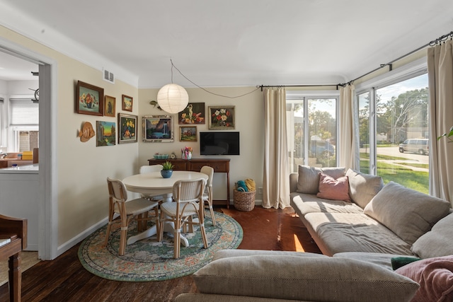 dining room featuring visible vents, baseboards, and wood finished floors