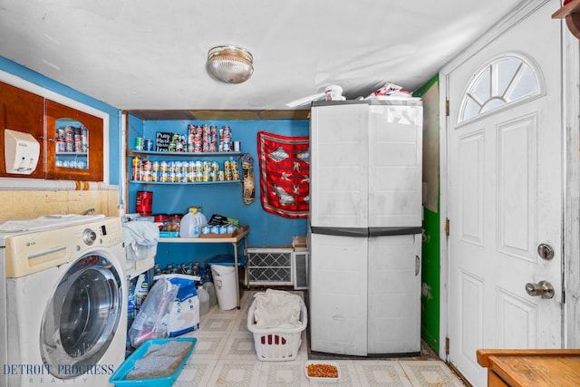 laundry room featuring tile patterned floors, laundry area, and washer / clothes dryer