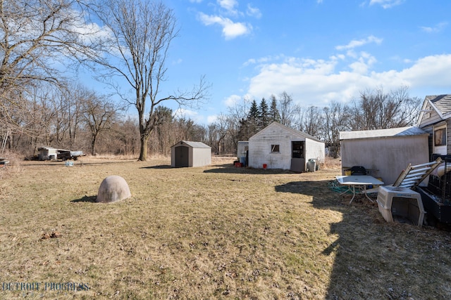 view of yard with an outbuilding and a storage shed