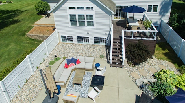 rear view of house with a patio area, an outdoor living space, a lawn, and a fenced backyard