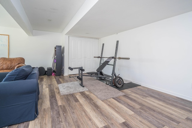 workout area with wood finished floors and baseboards