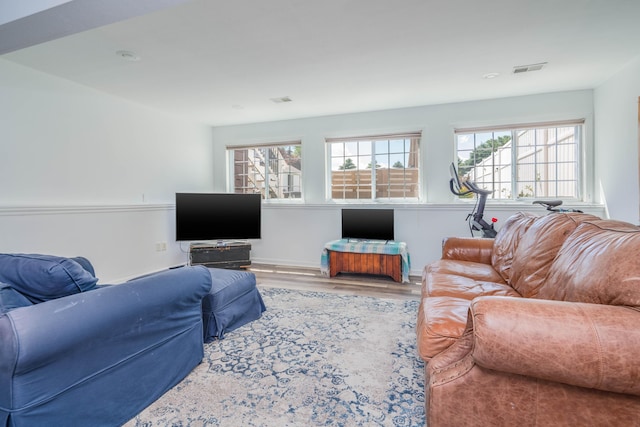 living room featuring wood finished floors and visible vents