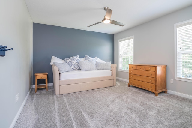 bedroom featuring baseboards, multiple windows, and carpet