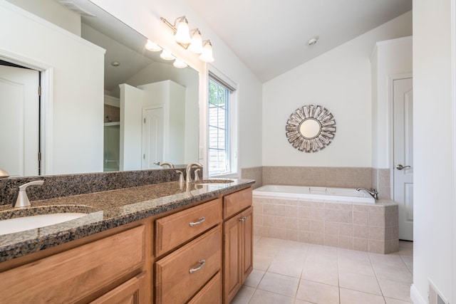 bathroom featuring a sink, lofted ceiling, and tile patterned floors