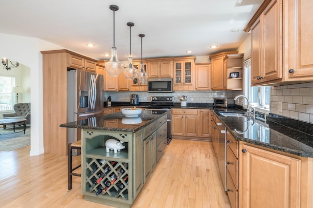 kitchen featuring open shelves, stainless steel appliances, light wood-type flooring, and a sink