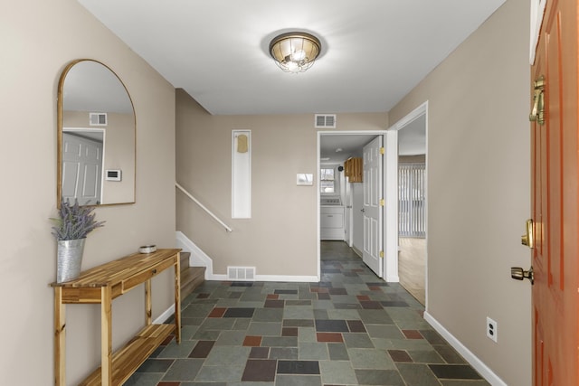 hall with stairway, baseboards, and visible vents