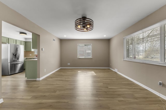 interior space with recessed lighting, light wood-type flooring, baseboards, and visible vents