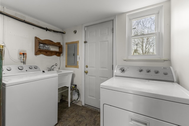 washroom featuring laundry area, electric panel, and washer and clothes dryer