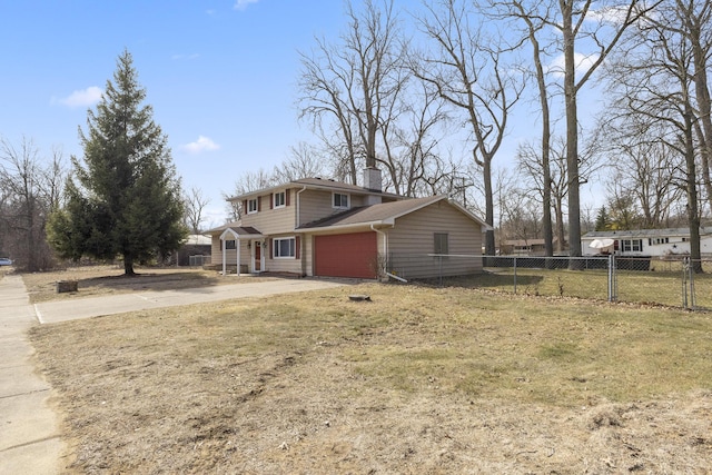 view of front of home with a garage, a front yard, driveway, and fence