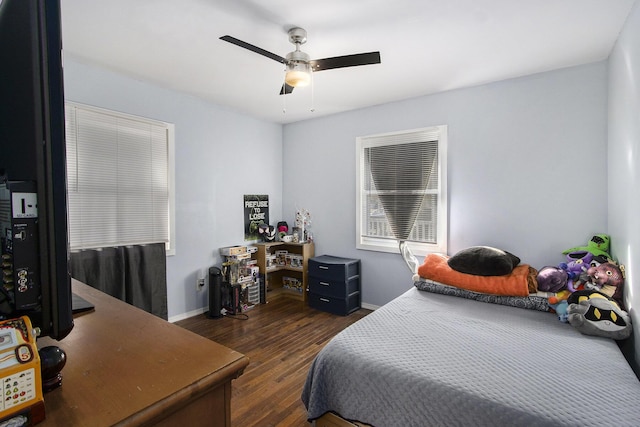 bedroom with dark wood-style floors, ceiling fan, and baseboards