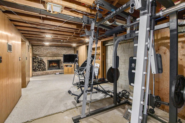 exercise area featuring a brick fireplace