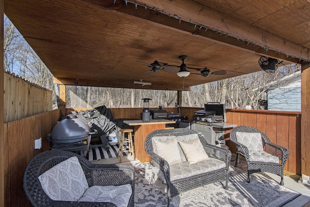 view of patio / terrace with grilling area, an outdoor living space, a fenced backyard, area for grilling, and a ceiling fan