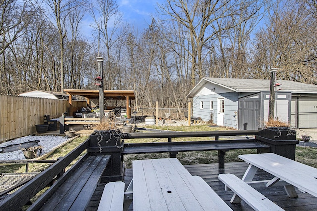 deck featuring an outdoor structure and a fenced backyard