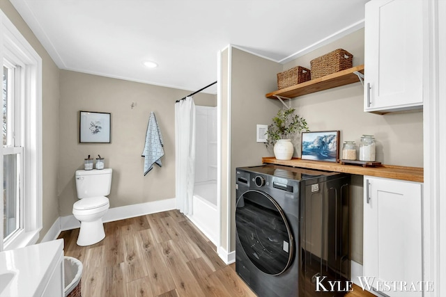 washroom featuring light wood finished floors, laundry area, washer / clothes dryer, and baseboards