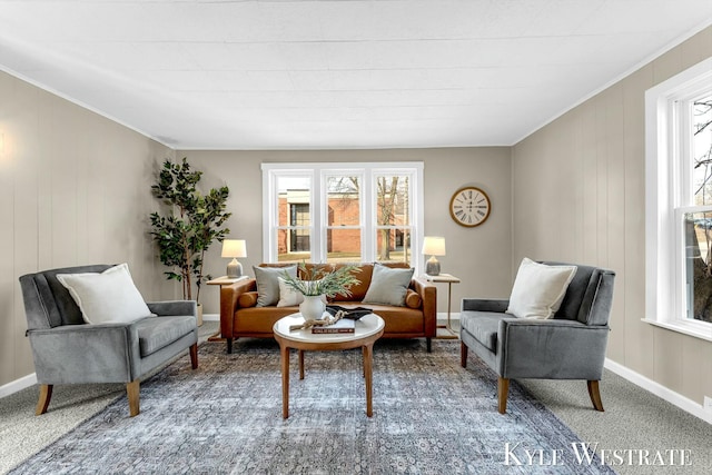 sitting room featuring baseboards, plenty of natural light, carpet, and crown molding