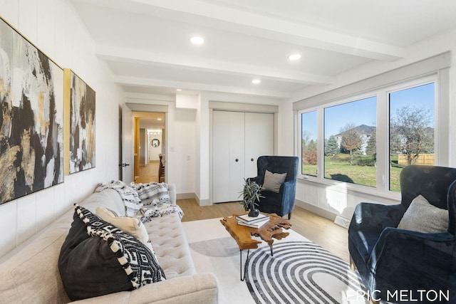 living room with recessed lighting, beamed ceiling, light wood-style flooring, and baseboards